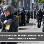 A police officer and an armed man fight near the Israeli Consulate in Munich