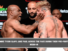 Mike Tyson slaps Jake Paul across the face during their pre-fight weigh-in